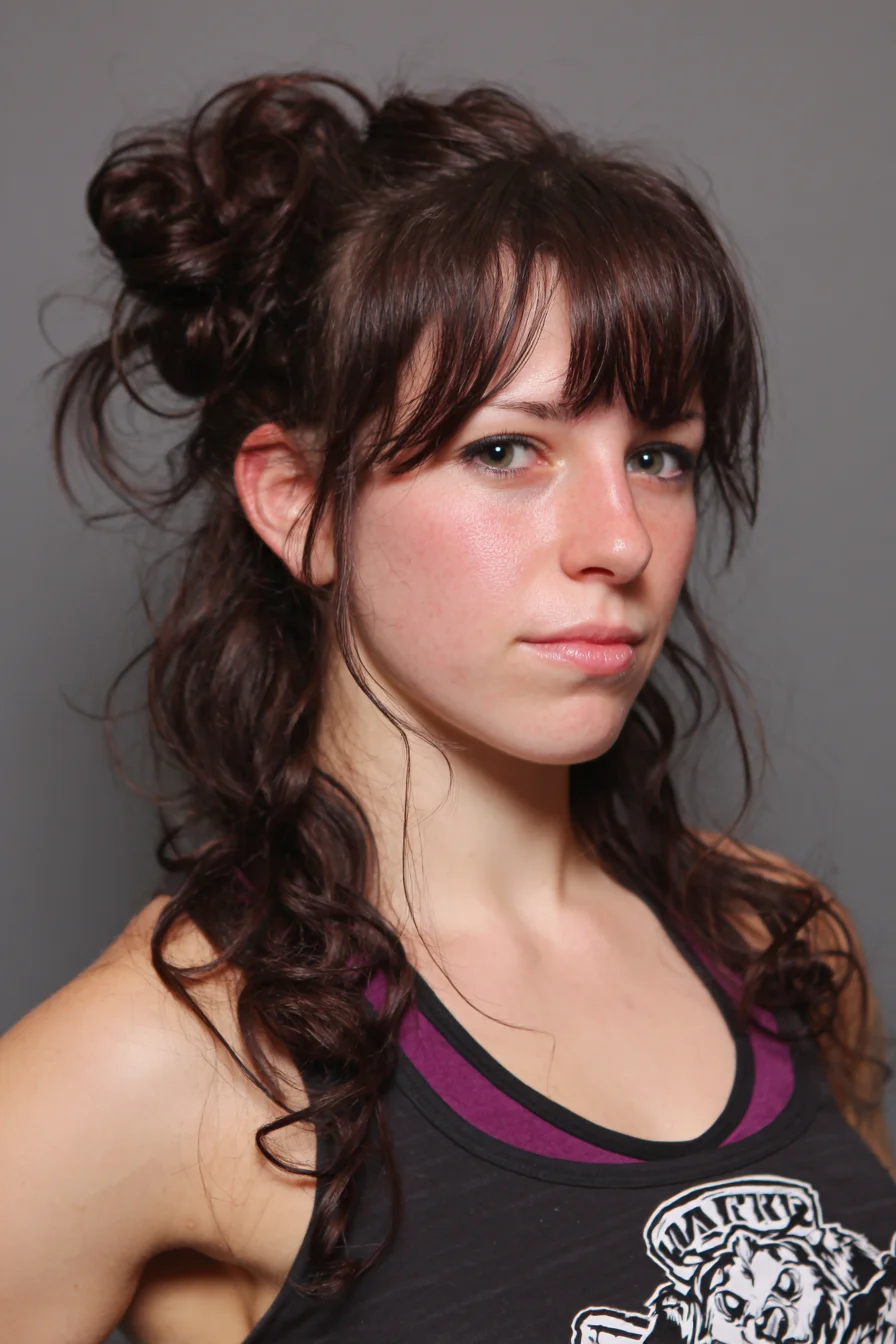 Textured Half-Up Messy Bun with Curtain Bangs and Loose Curls